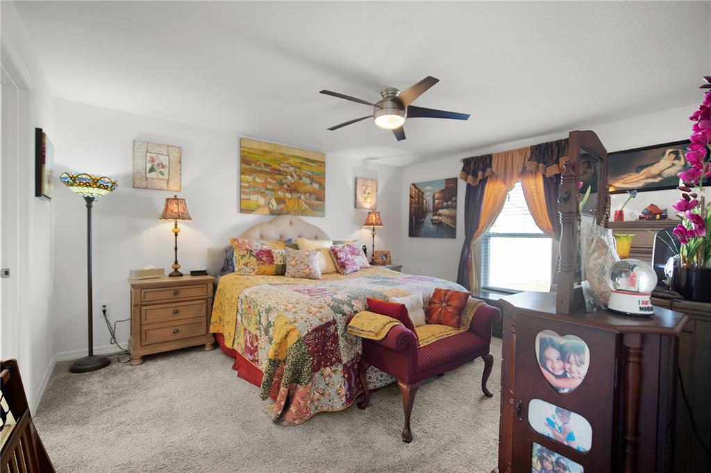 287 Inman Boulevard Winter Haven, FL 33881 - Photo 9 of 19 a bedroom with a bed a dresser next to a window