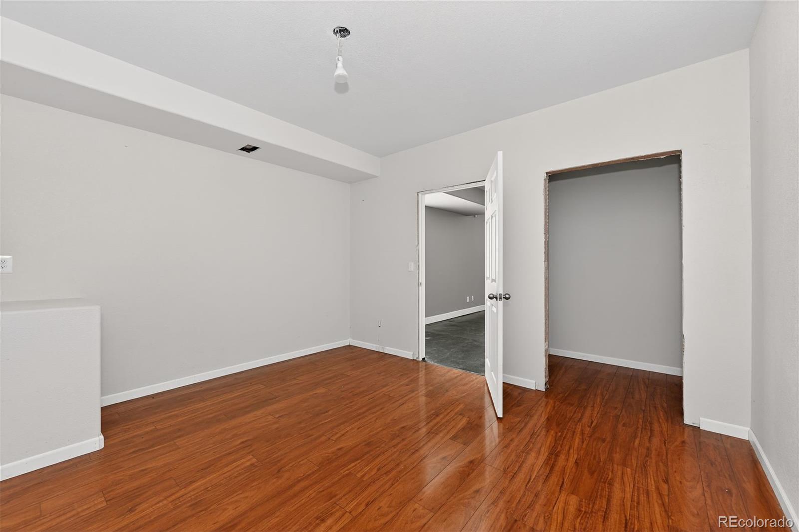 5085 Ridgewood Drive Johnstown, CO 80534 - Photo 15 of 30 a view of empty room with wooden floor