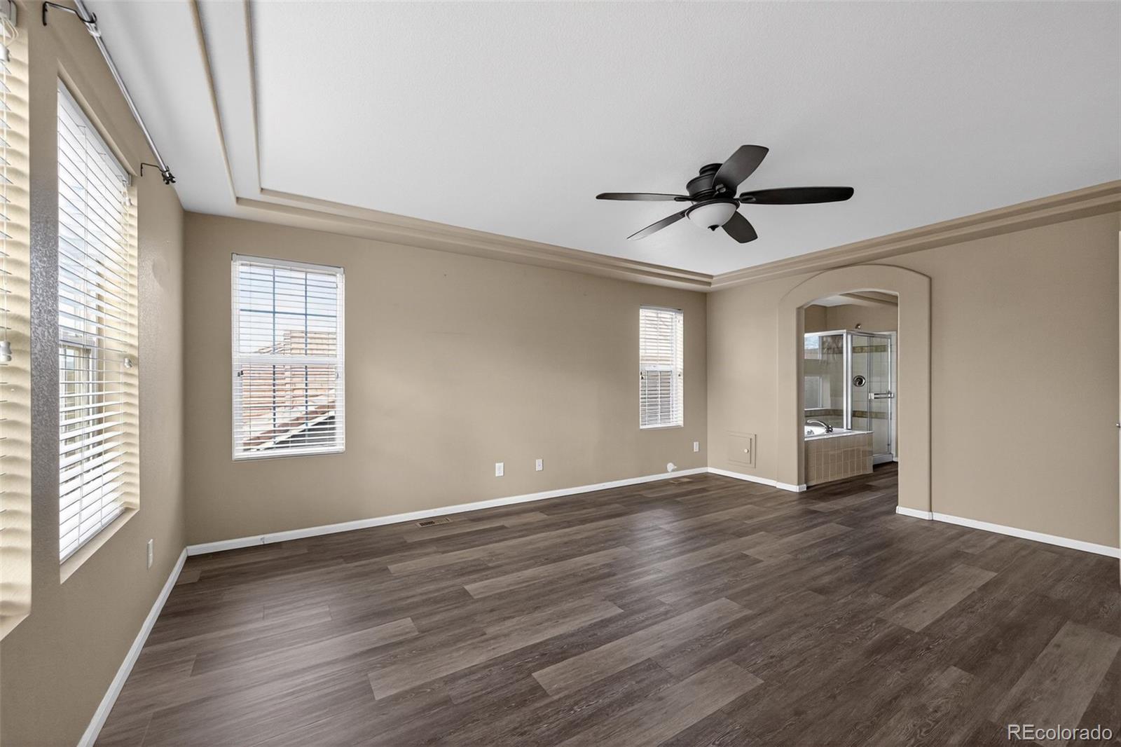 5085 Ridgewood Drive Johnstown, CO 80534 - Photo 17 of 30 a view of empty room with wooden floor and fan