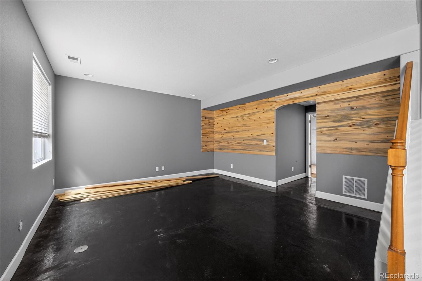 5085 Ridgewood Drive Johnstown, CO 80534 - Photo 19 of 30 a view of an empty room with wooden floor and a window