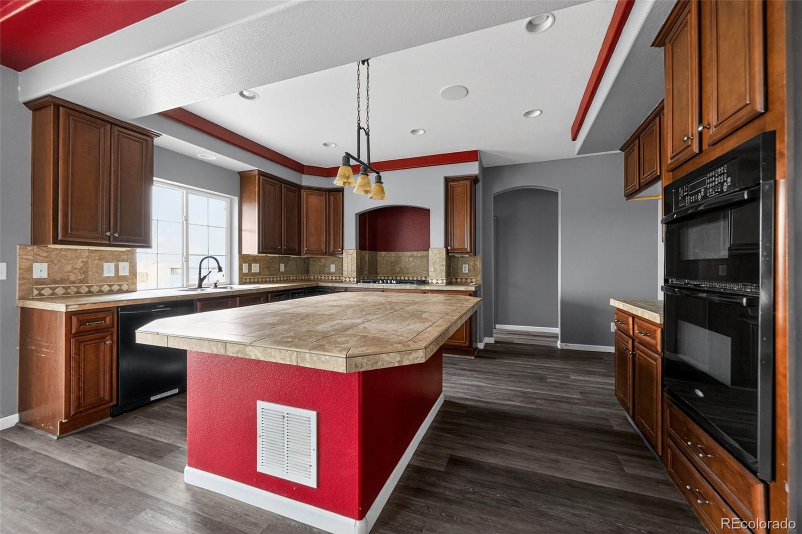 5085 Ridgewood Drive Johnstown, CO 80534 - Photo 2 of 30 a large kitchen with stainless steel appliances granite countertop a stove a sink dishwasher and a refrigerator with wooden floor