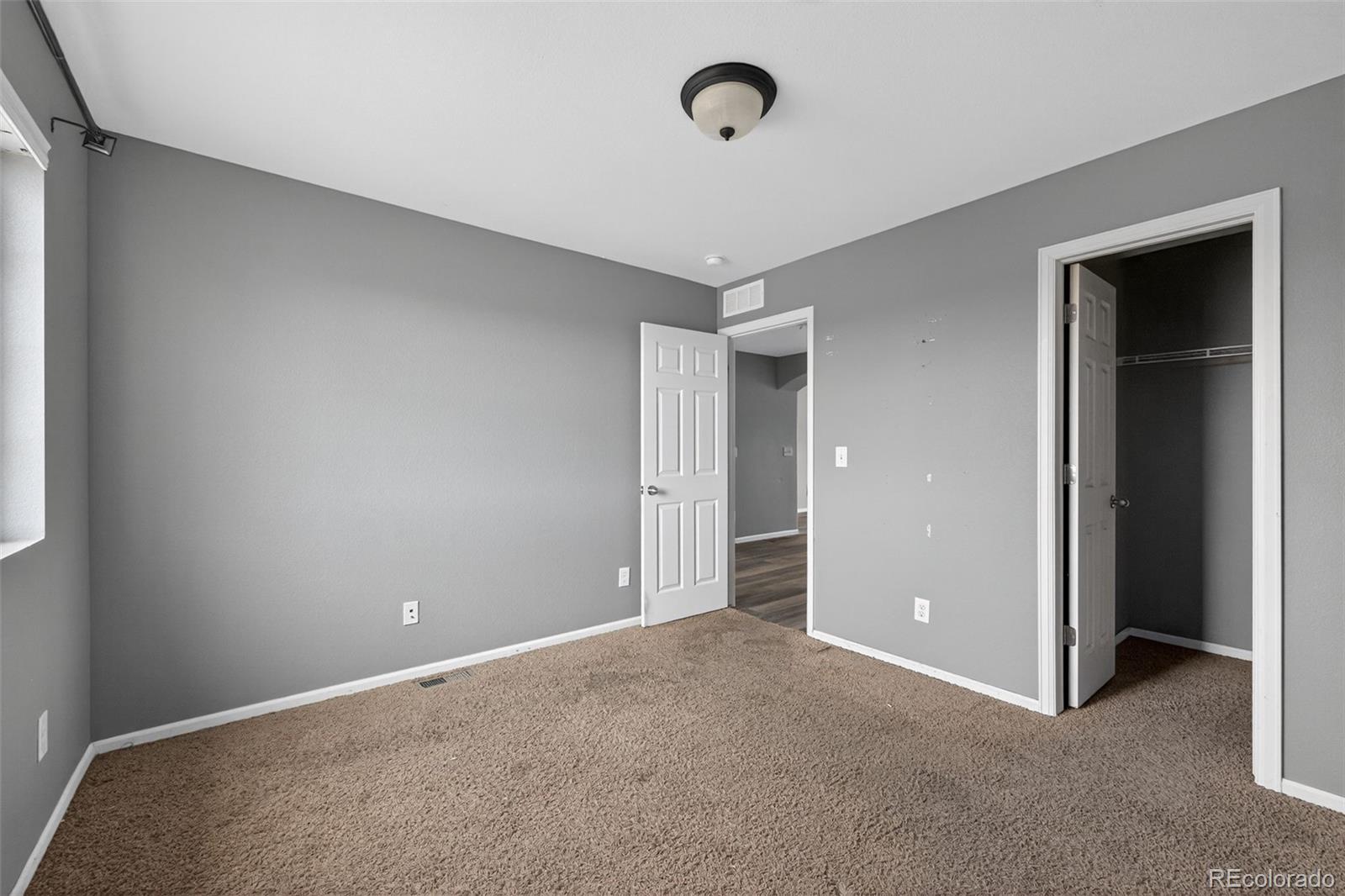 5085 Ridgewood Drive Johnstown, CO 80534 - Photo 22 of 30 an empty room with closet and windows