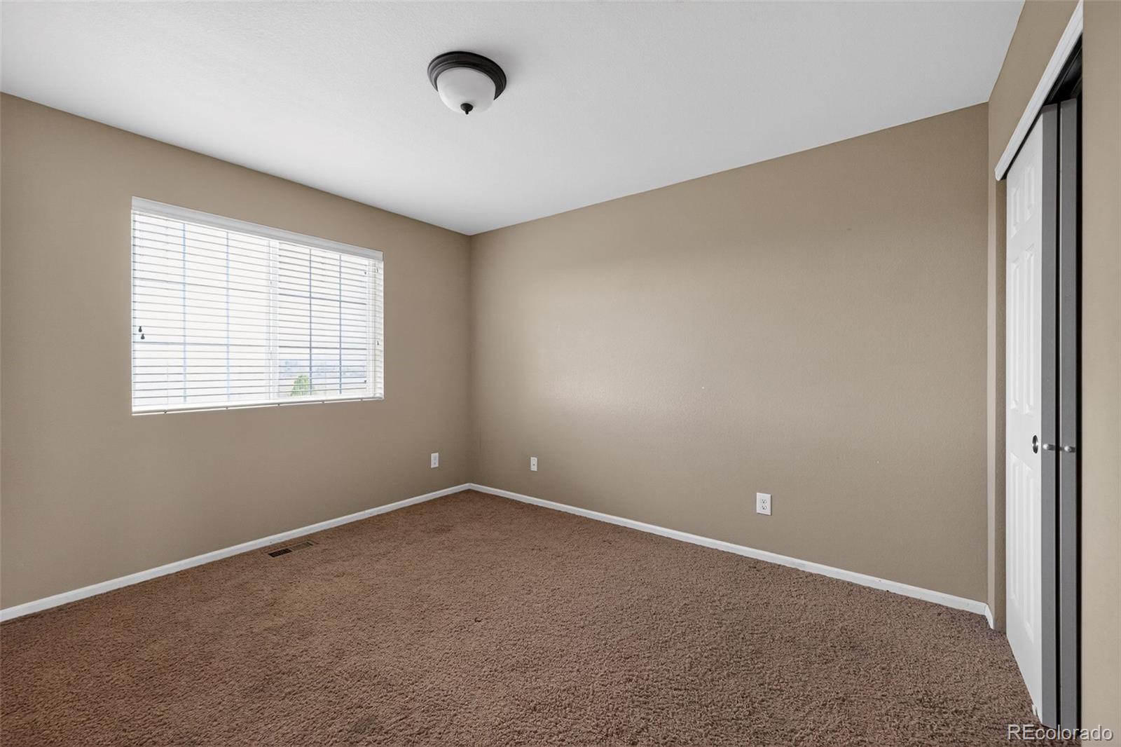 5085 Ridgewood Drive Johnstown, CO 80534 - Photo 23 of 30 an empty room with windows