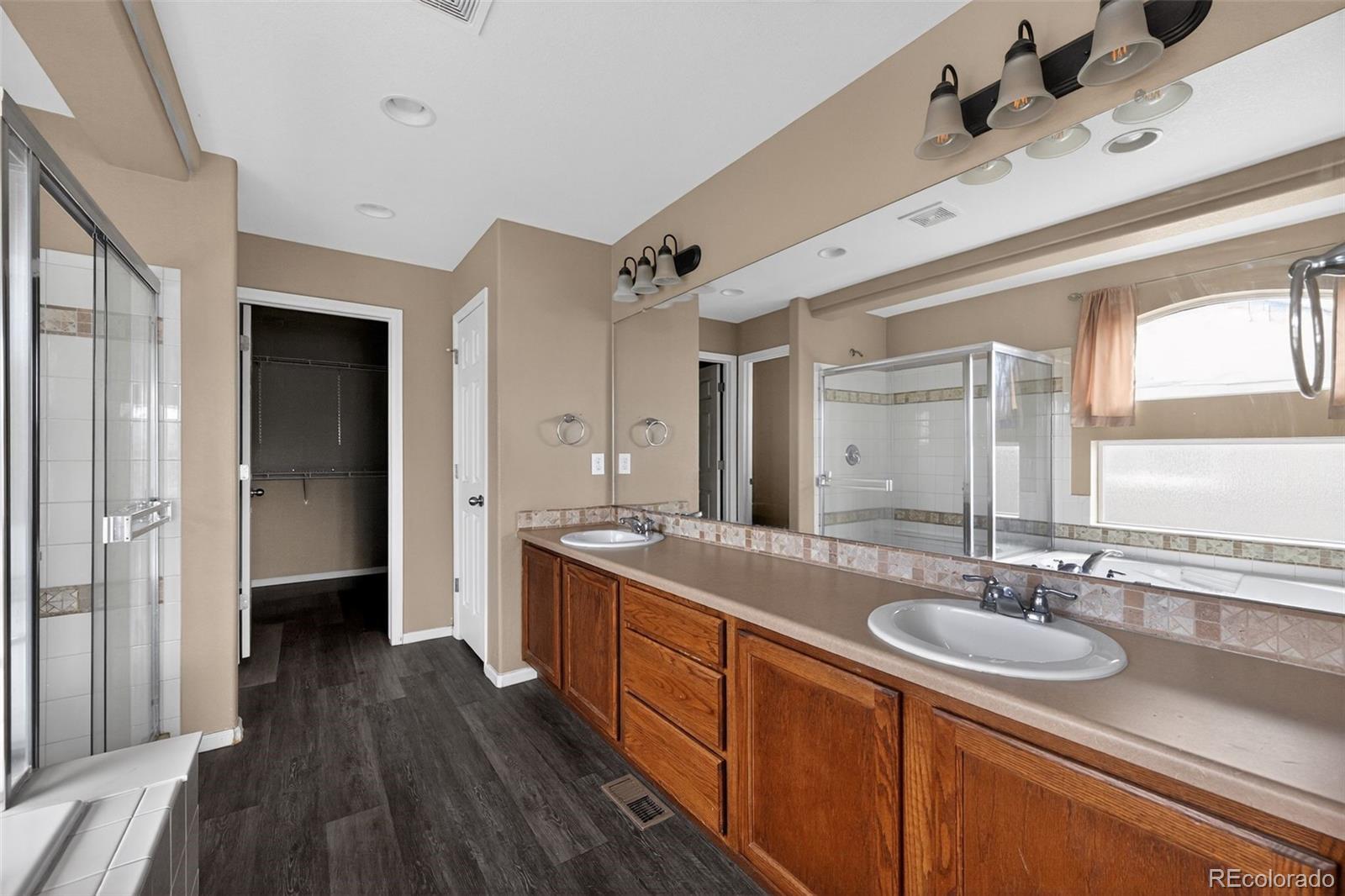 5085 Ridgewood Drive Johnstown, CO 80534 - Photo 26 of 30 a spacious bathroom with a double vanity sink a mirror and a shower