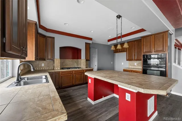 a kitchen with stainless steel appliances granite countertop a sink and a microwave