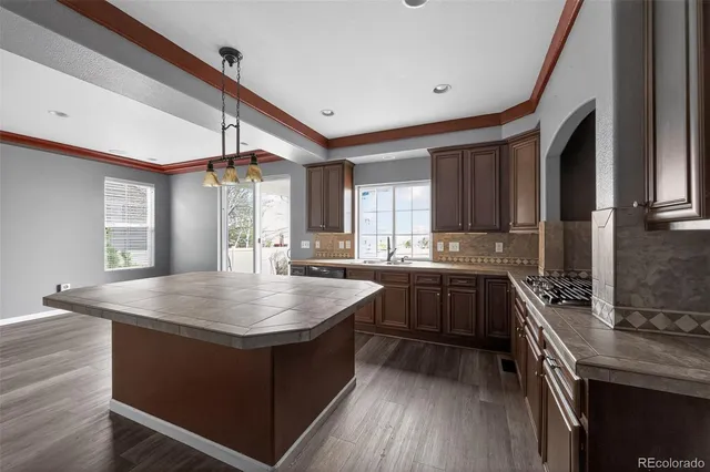 a kitchen with counter top space a sink cabinets and appliances
