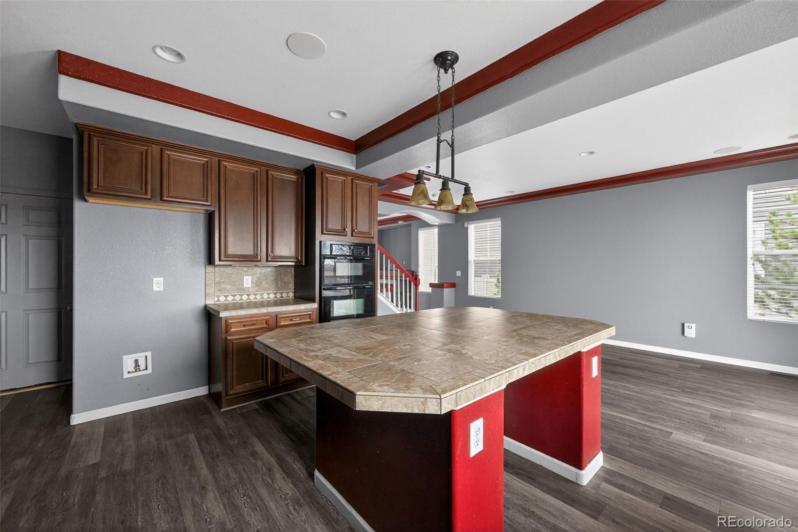 5085 Ridgewood Drive Johnstown, CO 80534 - Photo 6 of 30 a view of kitchen island with wooden floor and refrigerator