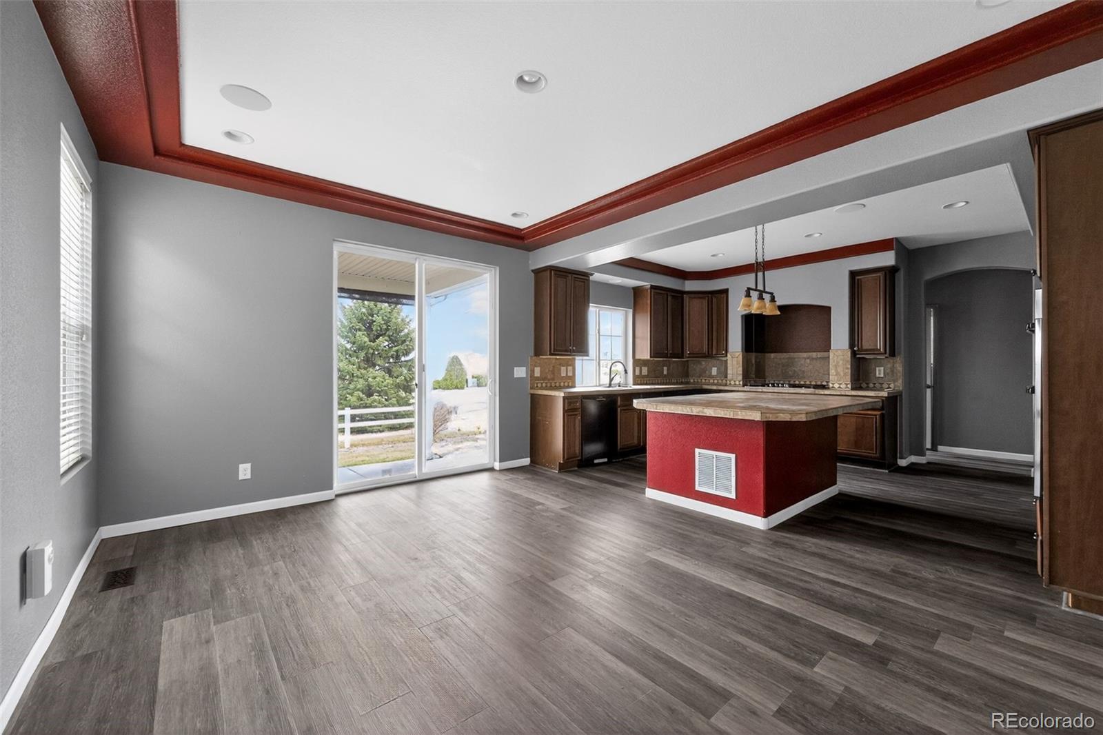 5085 Ridgewood Drive Johnstown, CO 80534 - Photo 9 of 30 a large kitchen with stainless steel appliances granite countertop a large stove a sink dishwasher and cabinets with wooden floor