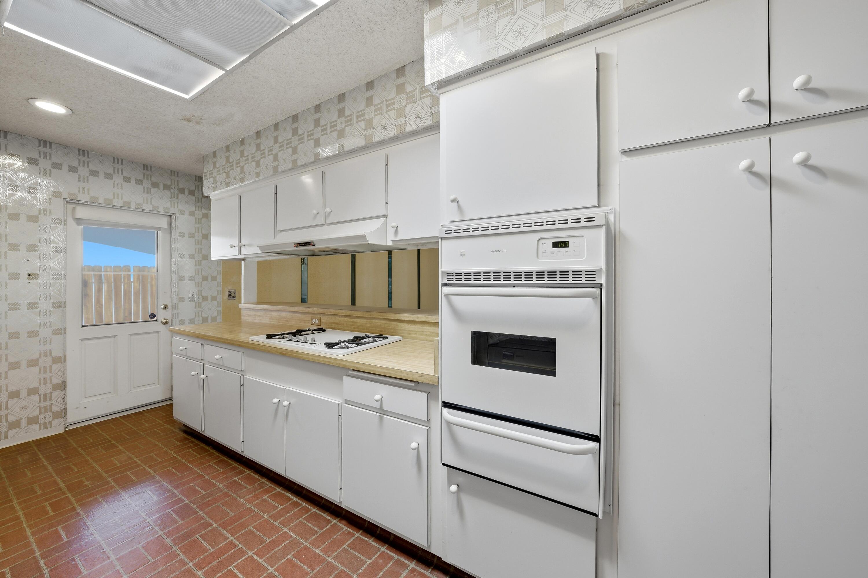 36990 Ferber Drive Rancho Mirage, CA 92270 - Photo 13 of 29 a kitchen with cabinets and white appliances