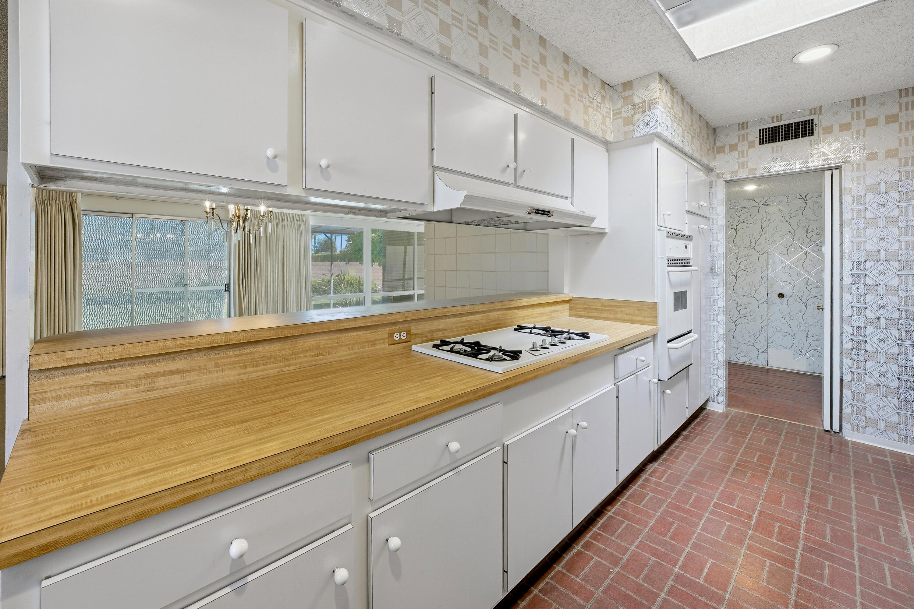 36990 Ferber Drive Rancho Mirage, CA 92270 - Photo 14 of 29 a large kitchen with white cabinets and white appliances