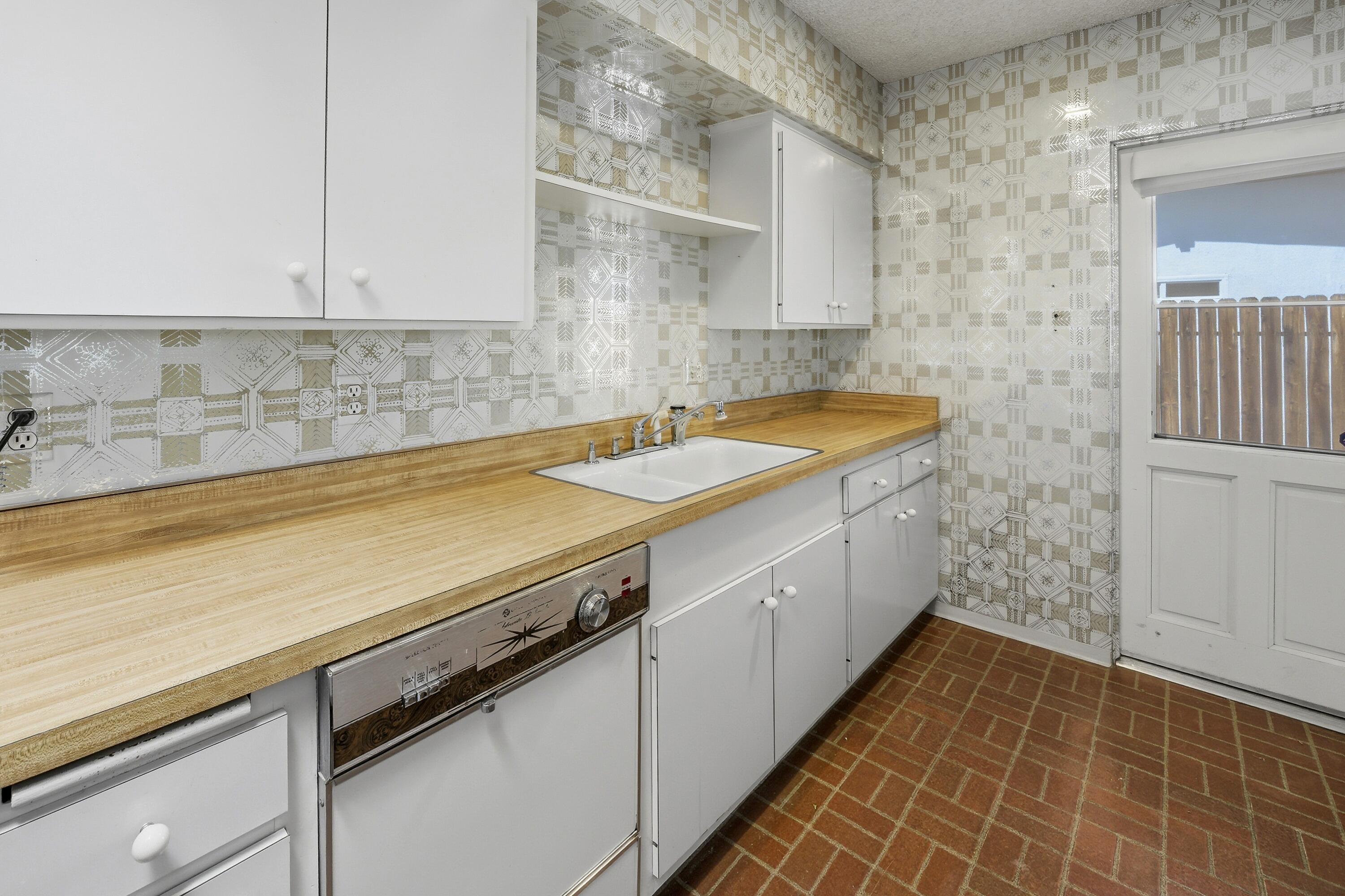 36990 Ferber Drive Rancho Mirage, CA 92270 - Photo 15 of 29 a utility room with granite countertop cabinets sink and dishwasher