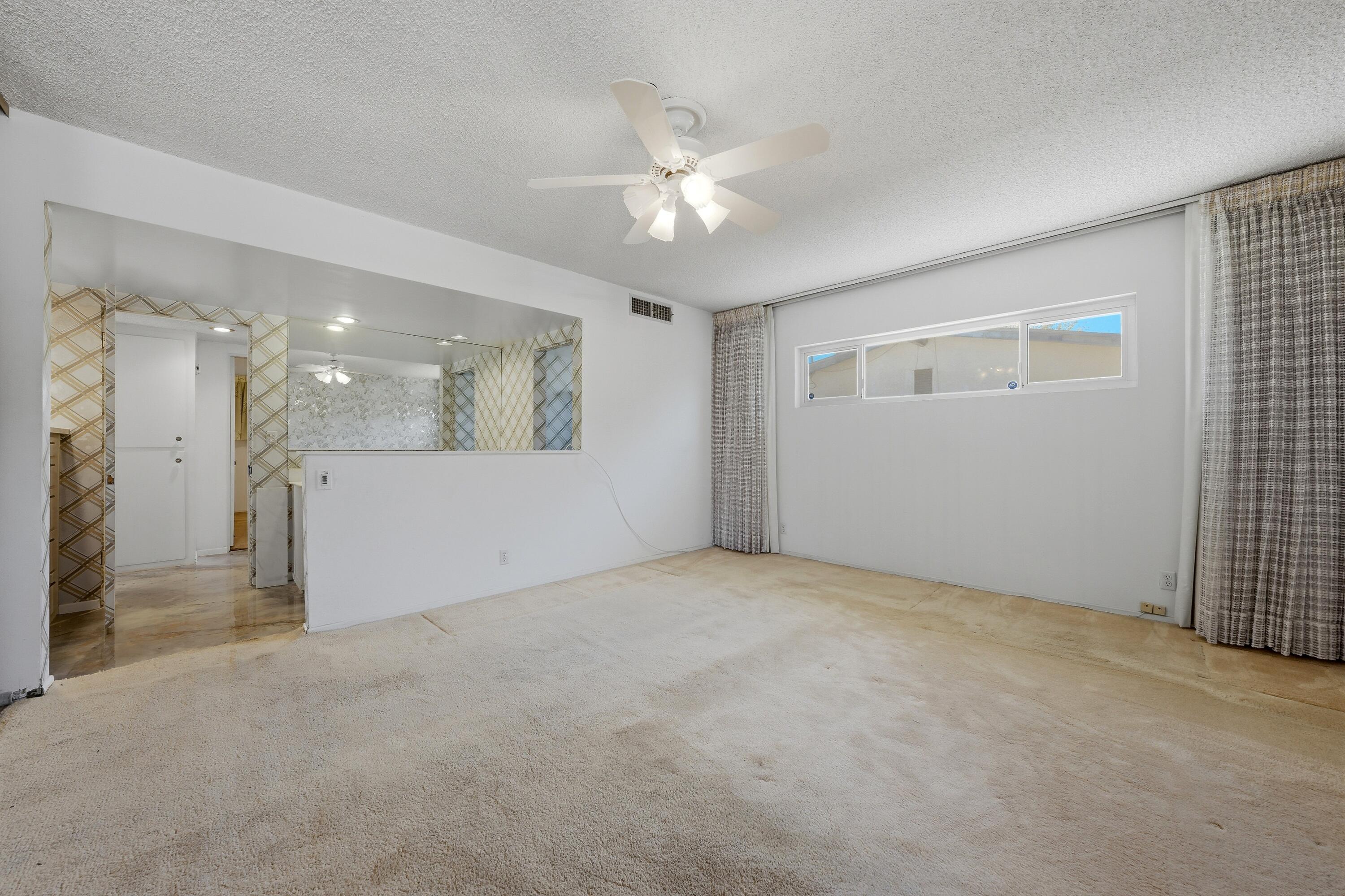 36990 Ferber Drive Rancho Mirage, CA 92270 - Photo 21 of 29 a view of a livingroom with a ceiling fan a kitchen space and a window