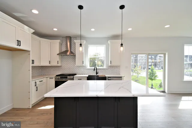 a kitchen with granite countertop a stove and a sink