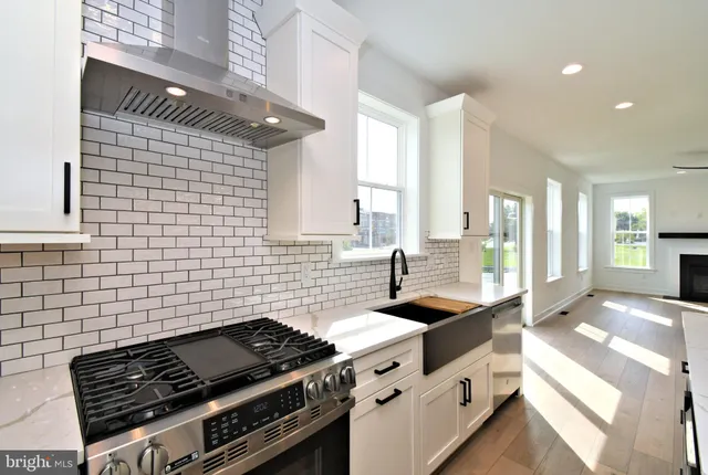 a kitchen with a sink a stove and a fireplace