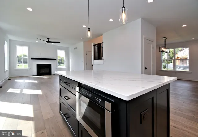 a kitchen with kitchen island a sink appliances and cabinets