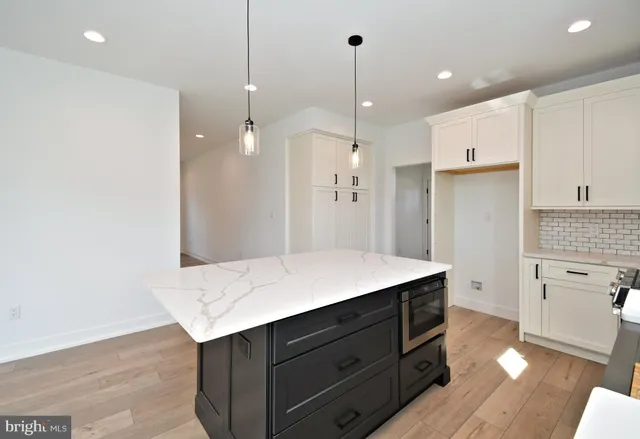 a view of an empty room with a fireplace and a window
