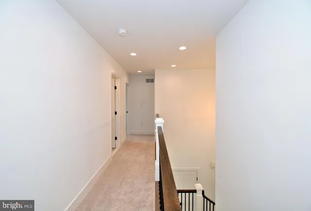 a view of a big room with a ceiling fan and a window