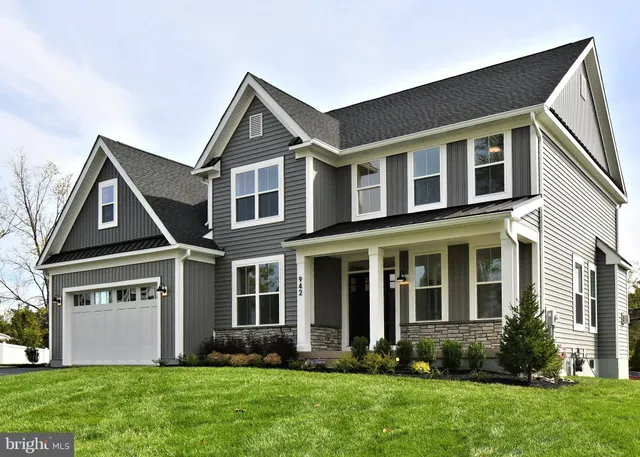 a view of a hallway with wooden floor and entryway