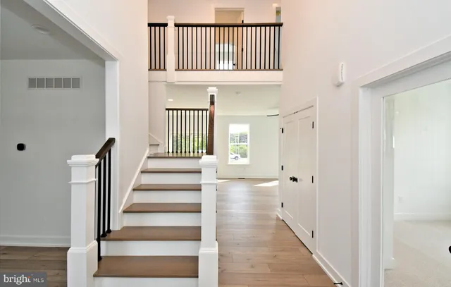 a view of an entryway with wooden floor and stairs