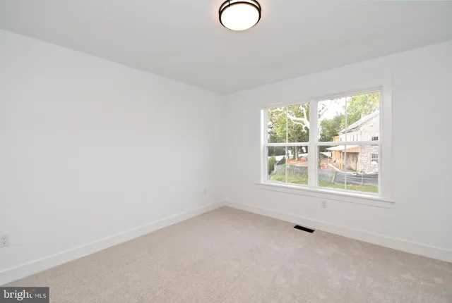 a bathroom with a bathtub and next to a window