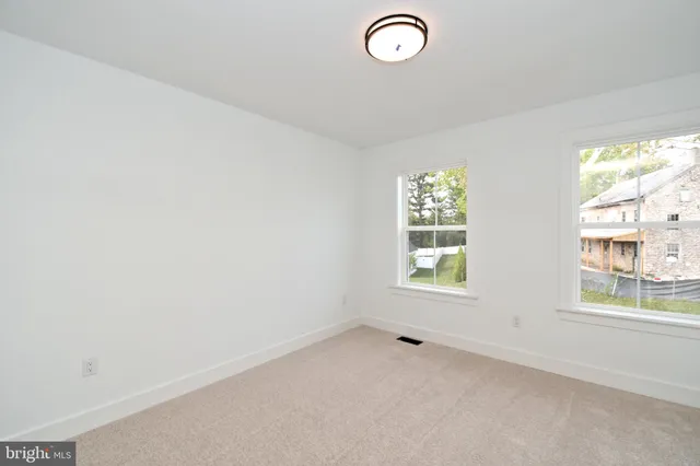 an empty room with windows and entrance