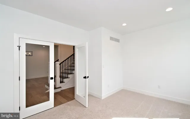 a view of a room with wooden floor