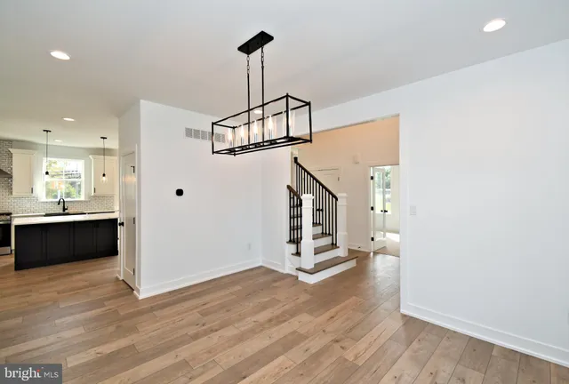 a kitchen with kitchen island a sink stainless steel appliances and cabinets