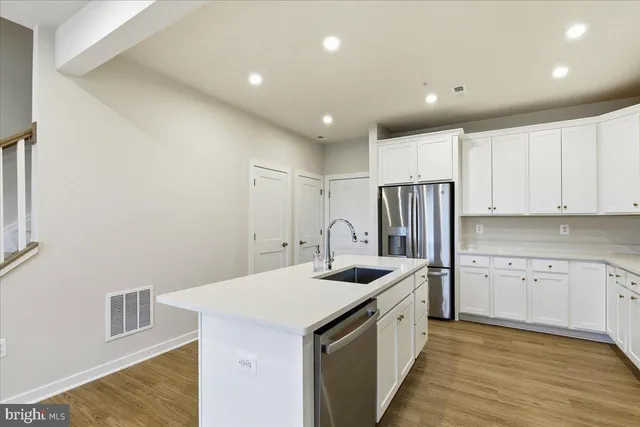a kitchen with refrigerator sink and cabinets