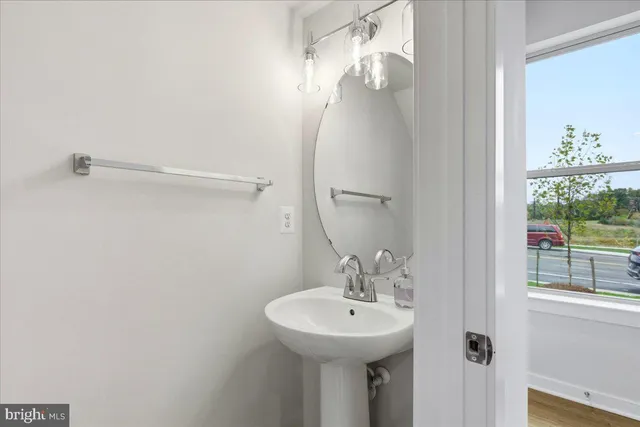 a bathroom with a sink a mirror and a window