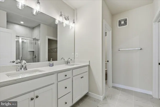 a bathroom with a double vanity sink and mirror