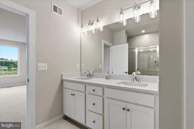a bathroom with a double vanity sink and a mirror