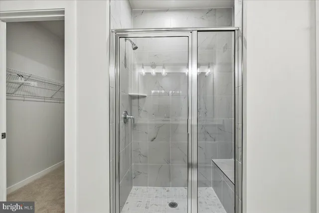 a bathroom with a glass shower door