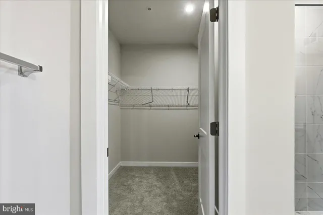a view of a hallway with wooden floor and entryway
