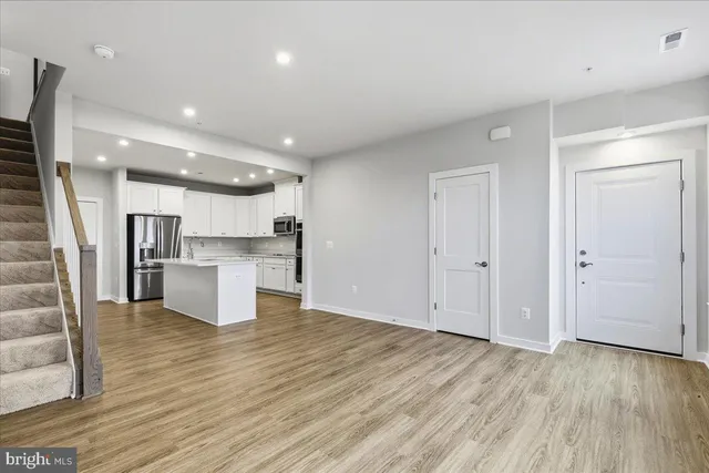 a view of kitchen dining table chairs microwave and cabinets