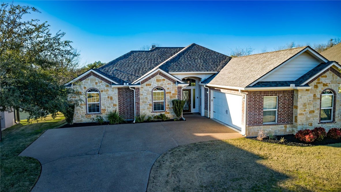 23 North Shore Circle Waco, TX 76708 - Photo 2 of 32 a front view of a house with a yard and garage