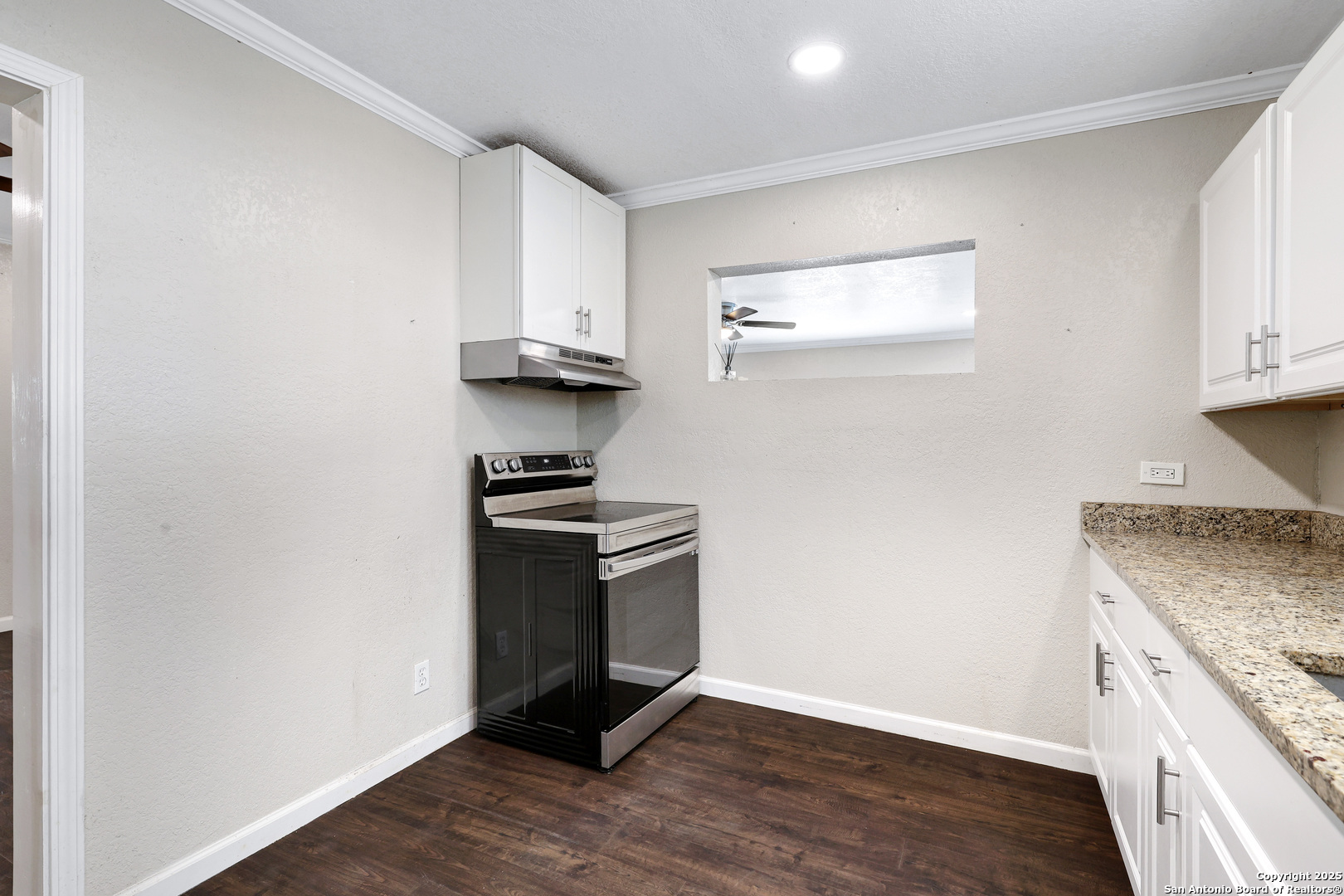 507 Hayden Avenue Devine, TX 78016 - Photo 14 of 26 a kitchen with granite countertop a stove and a sink