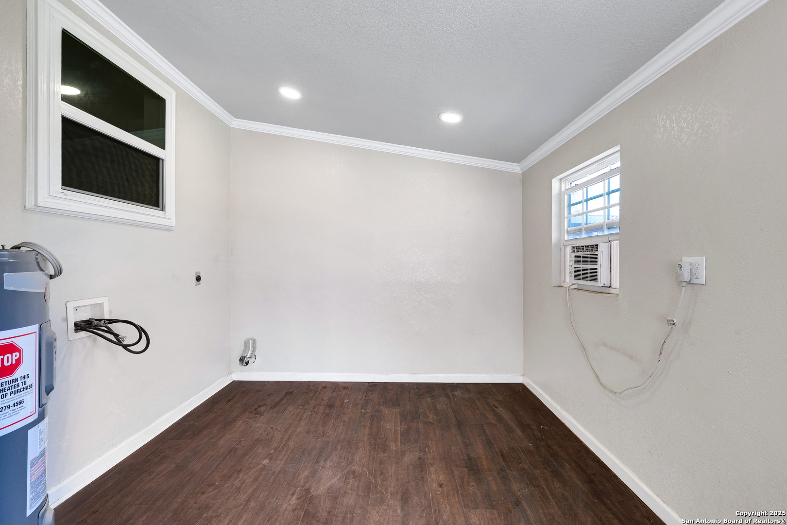 507 Hayden Avenue Devine, TX 78016 - Photo 20 of 26 a view of an empty room with wooden floor and windows