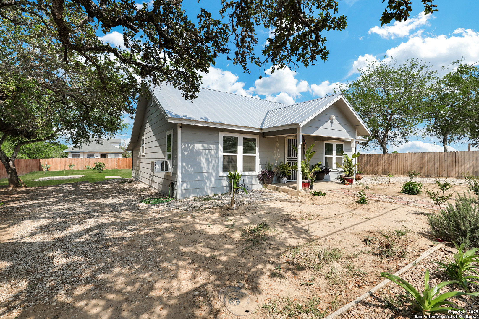 507 Hayden Avenue Devine, TX 78016 - Photo 2 of 26 a view of a house with a yard and tree