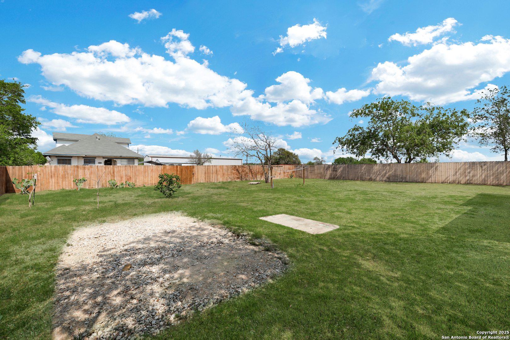 507 Hayden Avenue Devine, TX 78016 - Photo 23 of 26 a view of a backyard with a garden