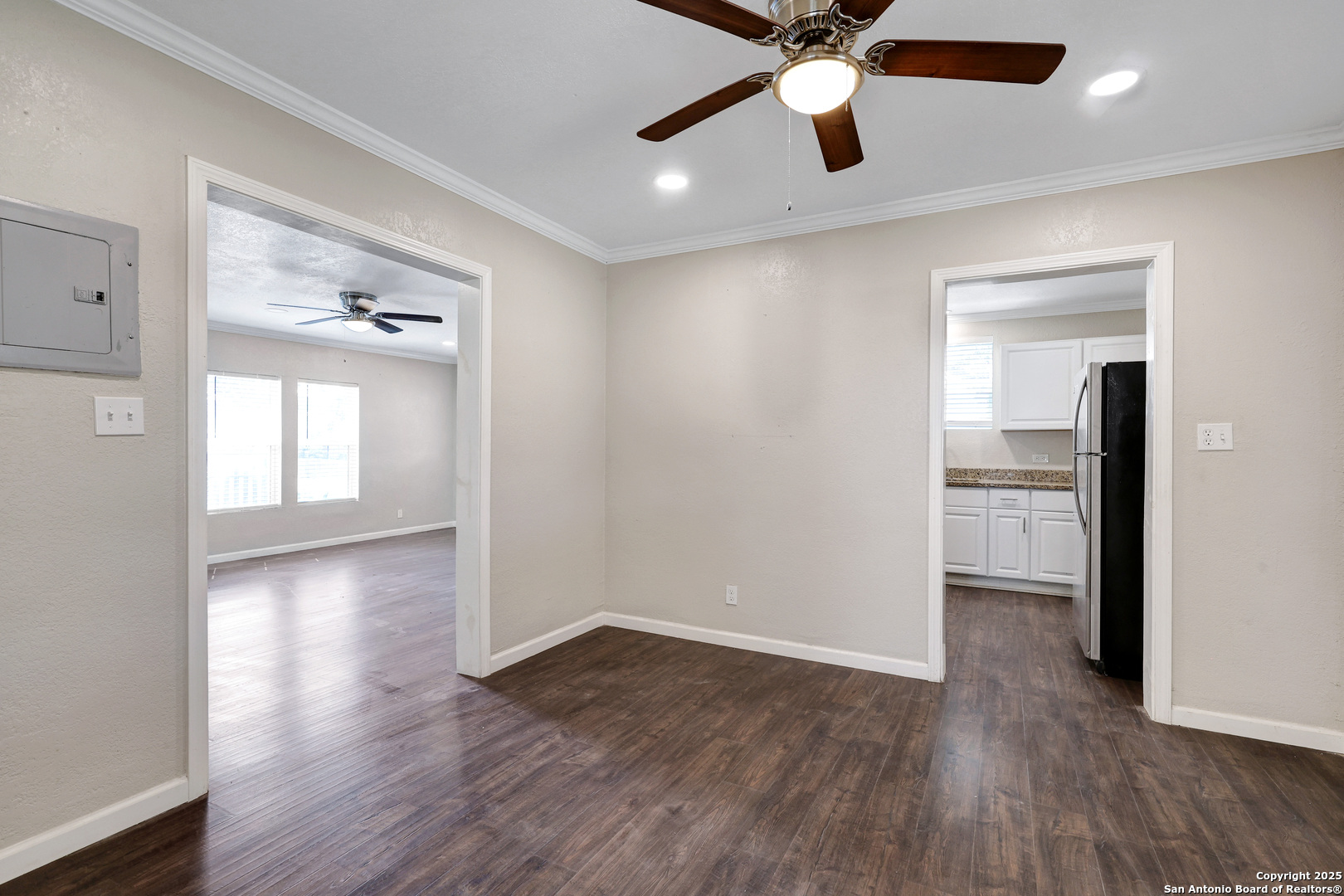 507 Hayden Avenue Devine, TX 78016 - Photo 10 of 26 wooden floor in an empty room with a window