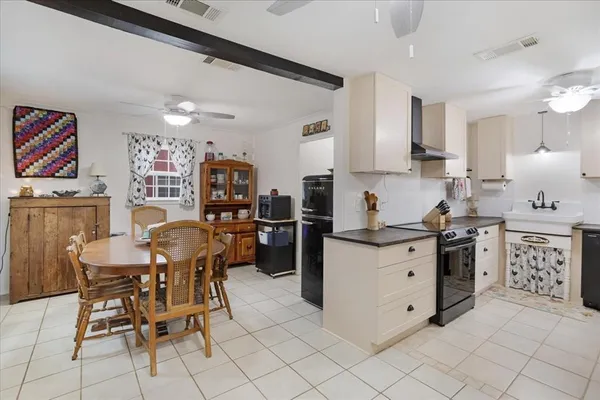 a kitchen with stainless steel appliances kitchen island granite countertop a sink and cabinets