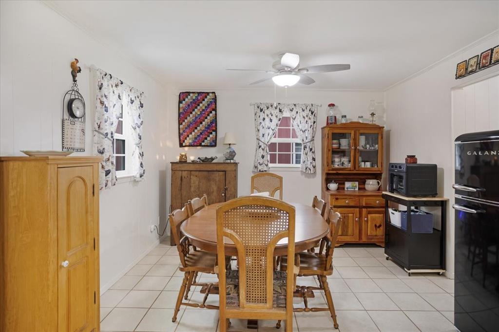 4149 County Road 4510 Commerce, TX 75428 - Photo 13 of 27 a dining room with furniture and window