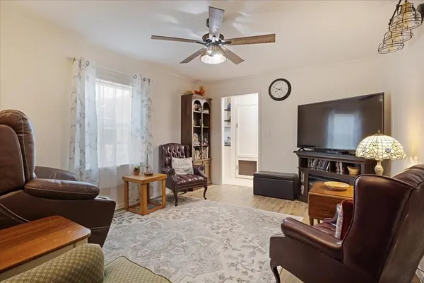 a living room with furniture ceiling fan and a rug