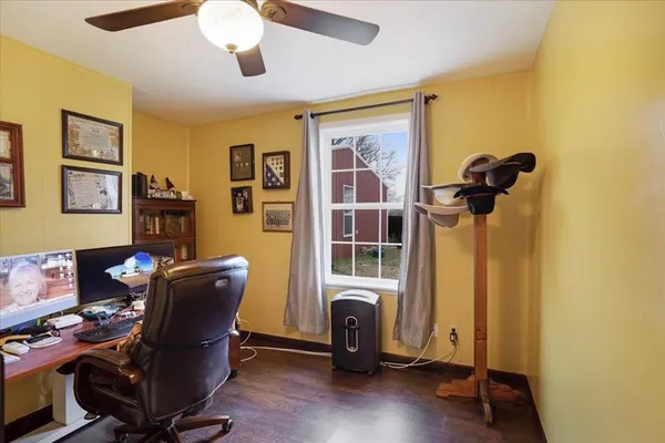 a view of a workspace with furniture and gym equipment