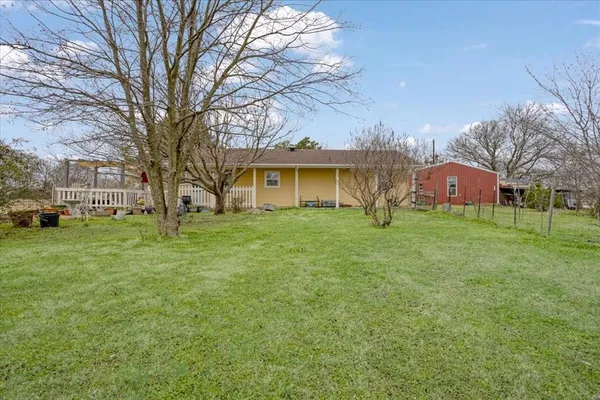 a house that has a tree in front of it