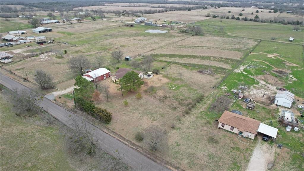 4149 County Road 4510 Commerce, TX 75428 - Photo 25 of 27 an aerial view of a house with a yard