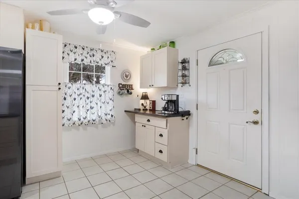a kitchen with granite countertop white cabinets and stainless steel appliances
