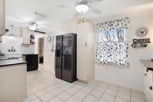 a kitchen with granite countertop a refrigerator and a sink