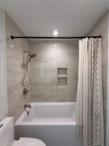 a bathroom with a shower and a bath tub