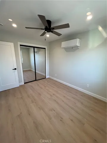 an empty room with fan and entrance